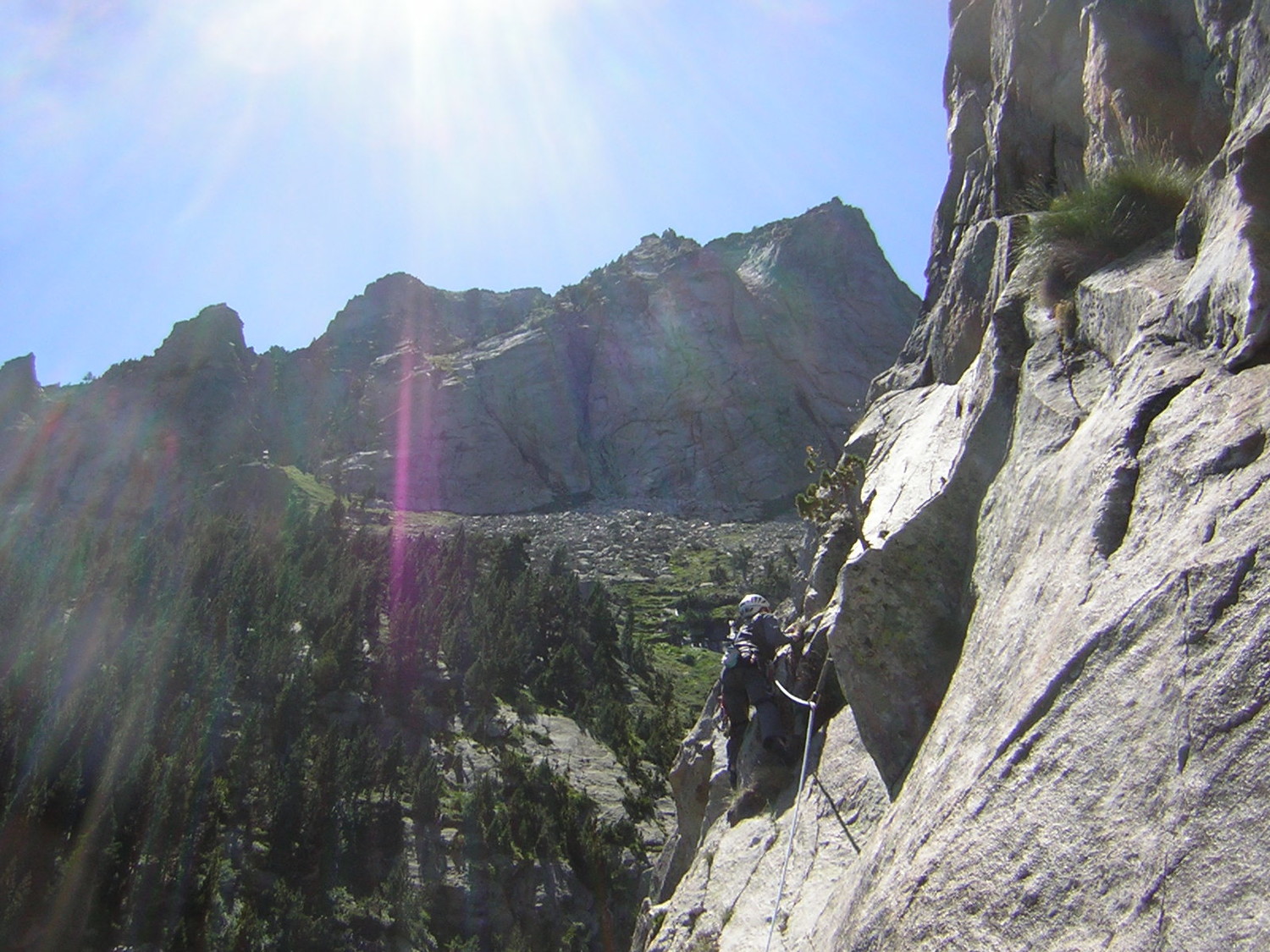 Pascal attaque la section de 6b, sur fond des aiguilles de Comalestorres.