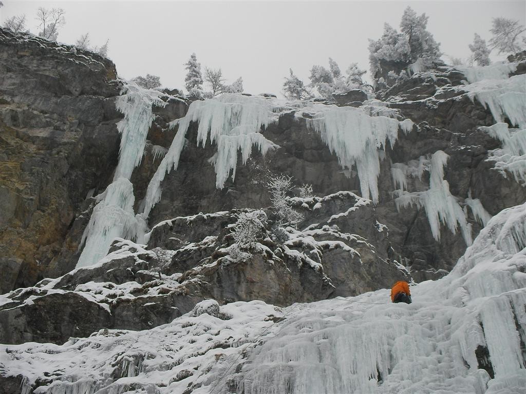 Un grimpeur dans la fin de L1 de Grimm et en haut à gauche la sortie de Reise (Kandersteg)